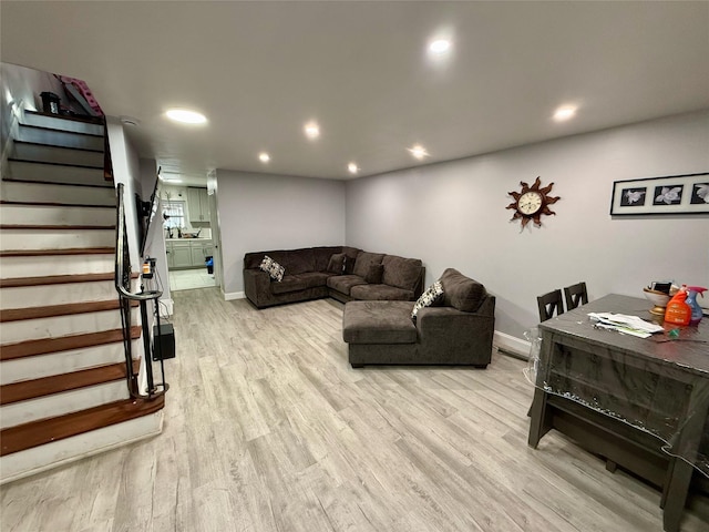 living area with stairway, recessed lighting, and light wood-style flooring