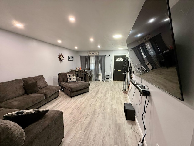 living room featuring light wood finished floors and recessed lighting