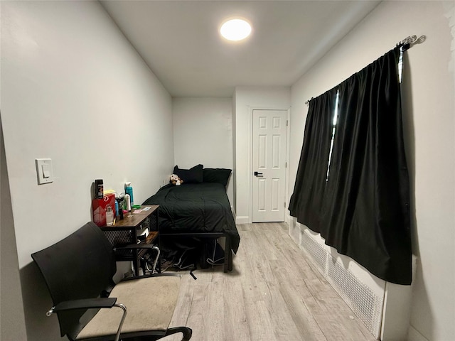 bedroom featuring light wood-style flooring and baseboards