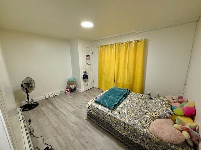 bedroom with baseboards and wood finished floors