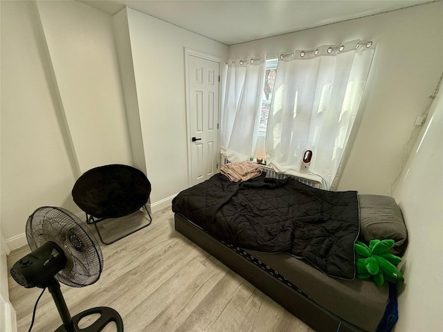 bedroom featuring baseboards and light wood-style floors