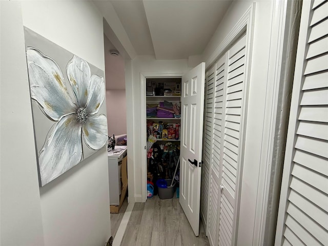 corridor with light wood-style floors