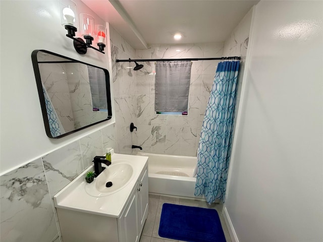 full bath with tile walls, shower / bath combination with curtain, and vanity