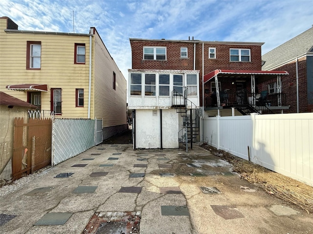 rear view of property featuring fence private yard