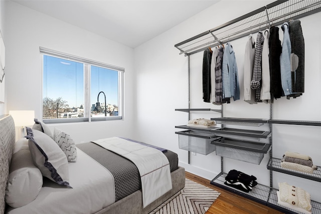 bedroom featuring wood finished floors and baseboards