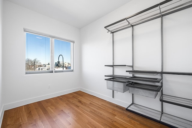 interior space with baseboards and wood finished floors