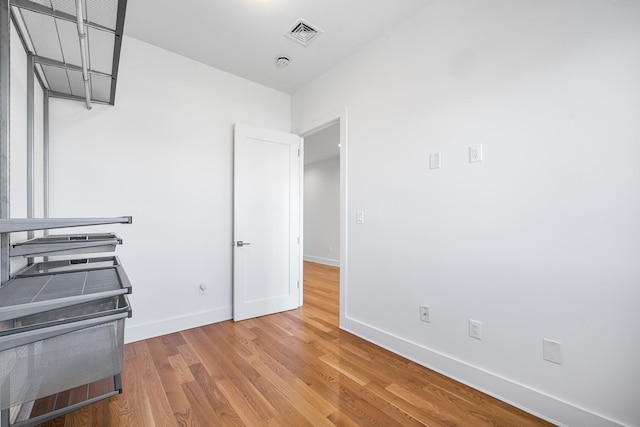 kitchen with baseboards, visible vents, and light wood finished floors