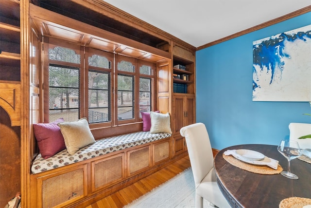 interior space featuring crown molding and light wood-style floors