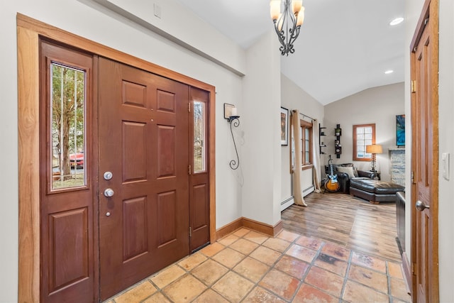 foyer with a notable chandelier, plenty of natural light, baseboards, and vaulted ceiling