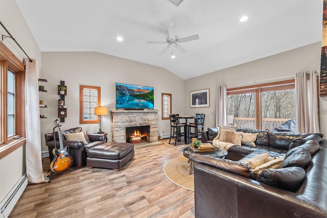 living area featuring a ceiling fan, lofted ceiling, light wood-style flooring, a baseboard heating unit, and baseboard heating