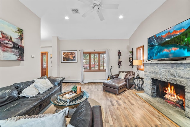 living area with visible vents, ceiling fan, vaulted ceiling, a fireplace, and wood finished floors