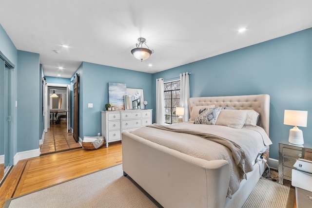 bedroom featuring recessed lighting, baseboards, and wood finished floors