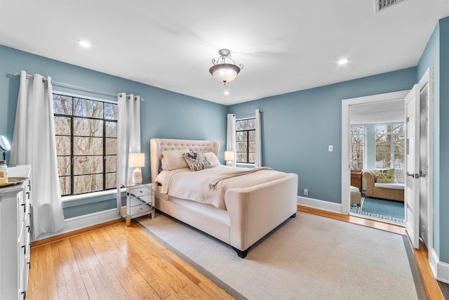 bedroom featuring recessed lighting, light wood-style flooring, and baseboards