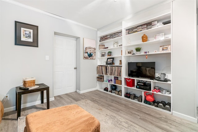 sitting room with wood finished floors, baseboards, and ornamental molding