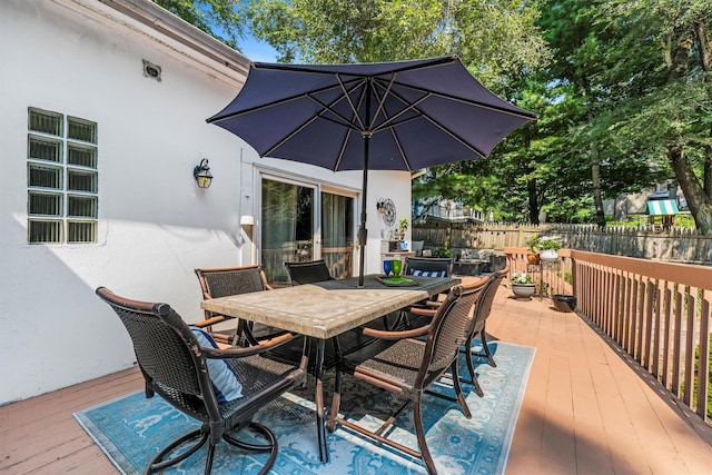 wooden deck featuring outdoor dining area and fence