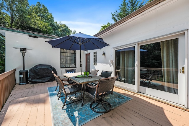 wooden terrace with outdoor dining space