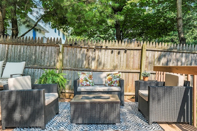 deck featuring an outdoor living space and fence