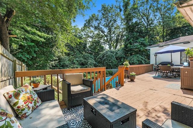 wooden terrace featuring an outdoor living space, outdoor dining area, and fence