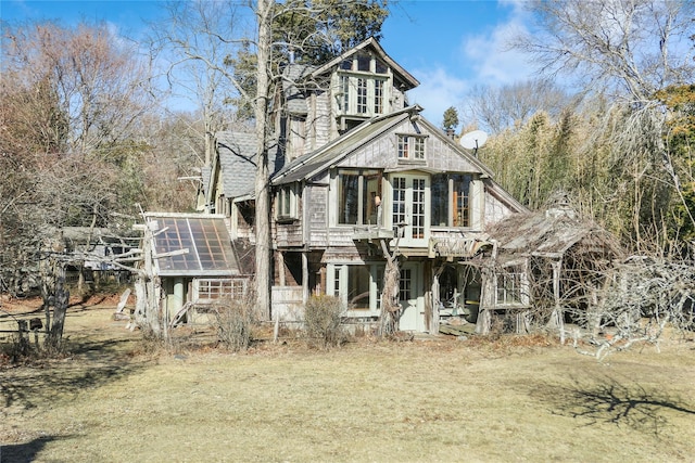 view of front facade with a wooden deck and a front yard