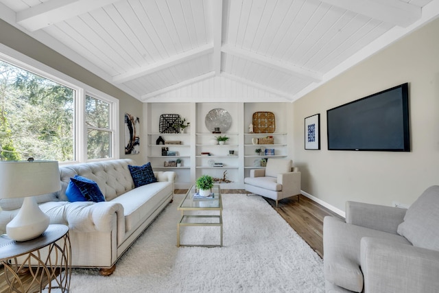 living area with wooden ceiling, lofted ceiling with beams, baseboards, and wood finished floors