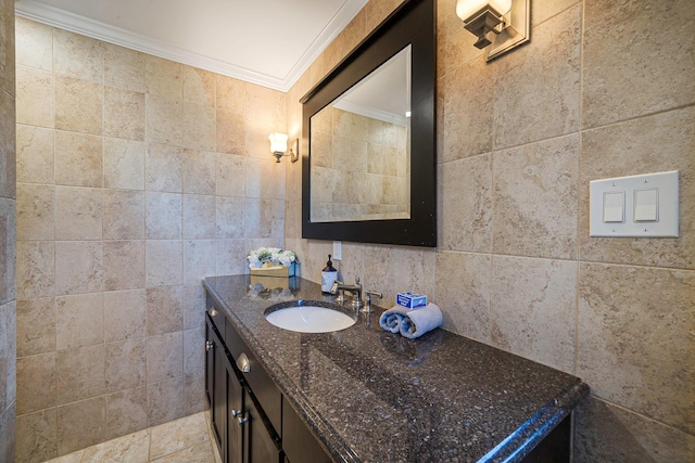 bathroom with tile walls, crown molding, and vanity