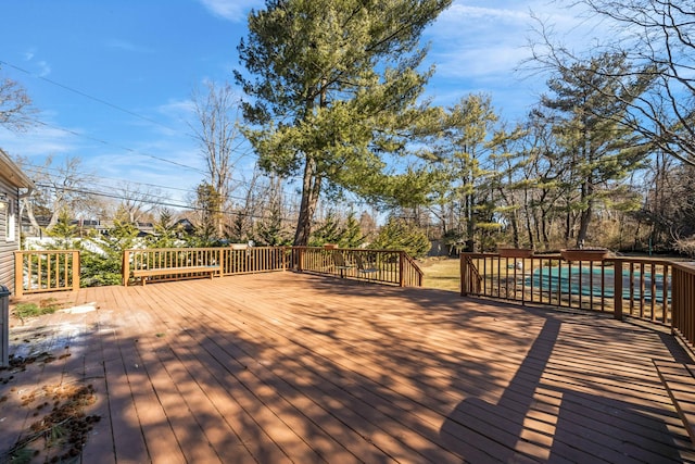 wooden terrace featuring a swimming pool