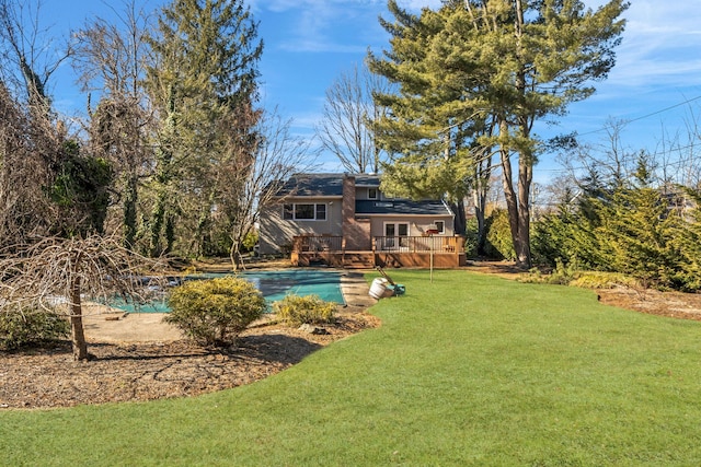 exterior space with an outdoor pool and a deck