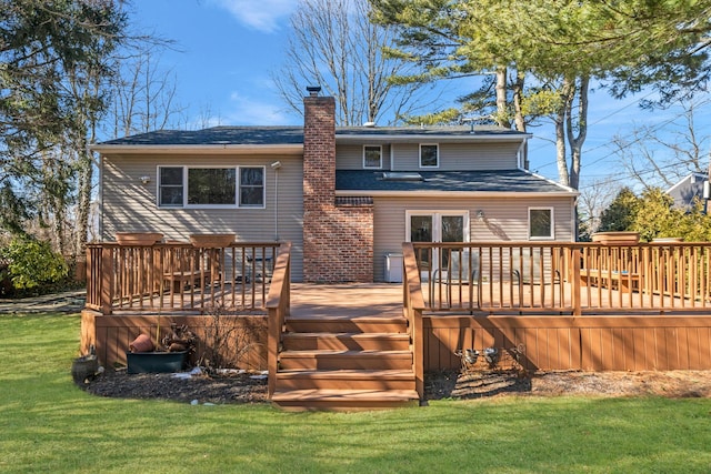 back of property with a yard, a chimney, and a wooden deck