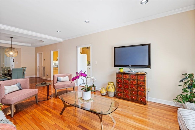 living room featuring ornamental molding, recessed lighting, light wood-style flooring, and baseboards