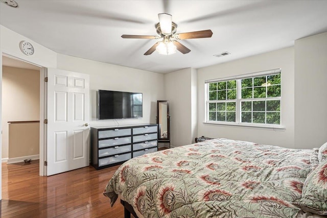 bedroom featuring ceiling fan, wood finished floors, and visible vents