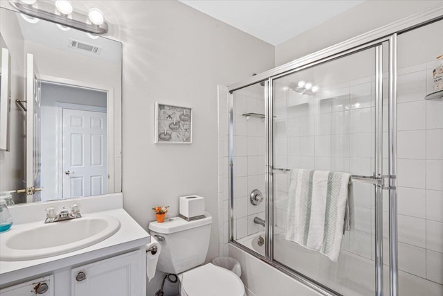 bathroom with visible vents, shower / bath combination with glass door, vanity, and toilet