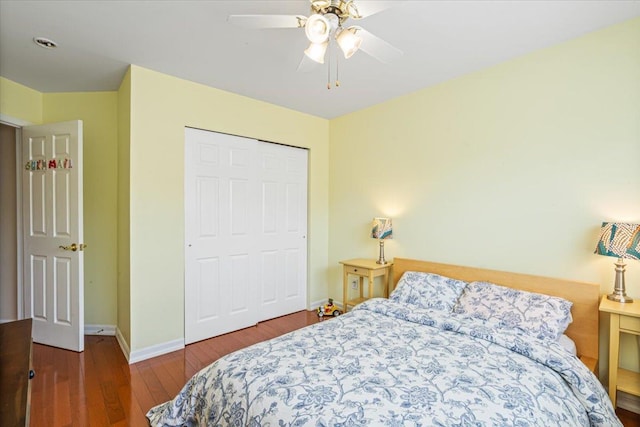 bedroom featuring a closet, wood finished floors, a ceiling fan, and baseboards