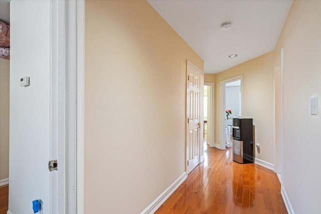 hallway with baseboards and light wood finished floors