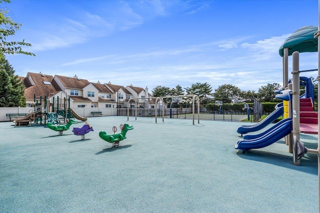 communal playground with fence and a residential view