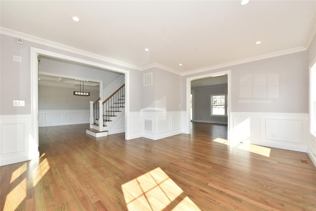 empty room with visible vents, stairway, wood finished floors, and recessed lighting