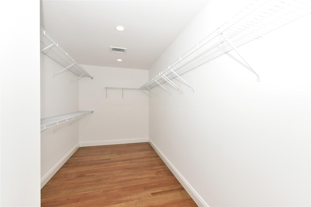 spacious closet with wood finished floors and visible vents