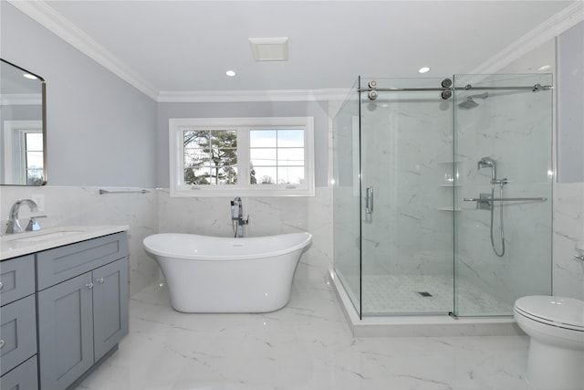 bathroom featuring a freestanding tub, marble finish floor, crown molding, and vanity