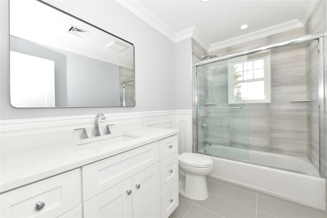 full bath with tile patterned flooring, toilet, combined bath / shower with glass door, wainscoting, and crown molding