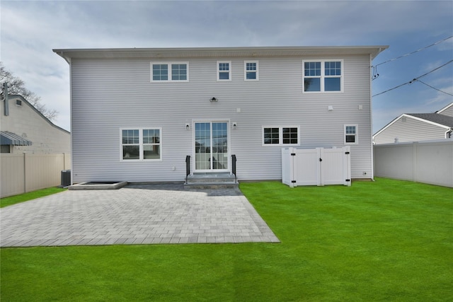 back of property with a yard, a fenced backyard, and a patio