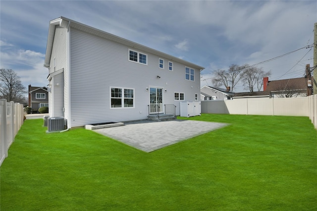 rear view of property featuring a patio area, a fenced backyard, central AC unit, and a yard