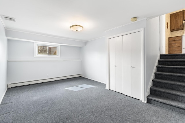 unfurnished bedroom with visible vents, dark colored carpet, crown molding, a baseboard heating unit, and a closet