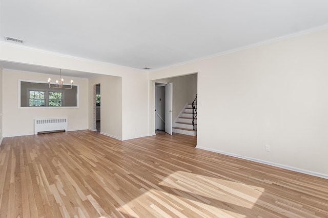 unfurnished living room with visible vents, stairs, light wood finished floors, radiator heating unit, and an inviting chandelier