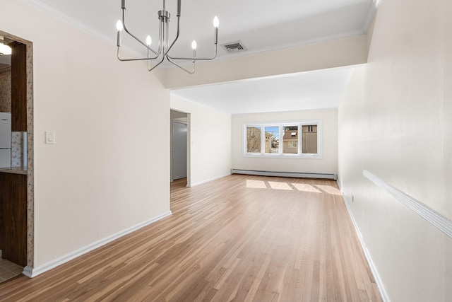 interior space featuring a baseboard heating unit, baseboards, visible vents, and light wood-style floors