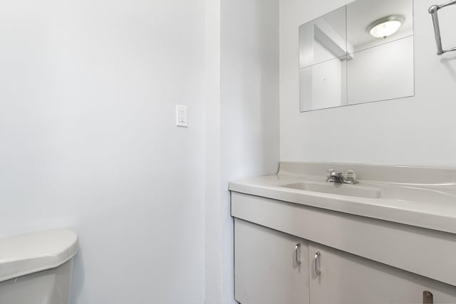 bathroom featuring toilet and vanity