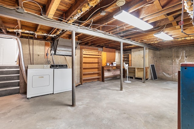 unfinished below grade area featuring washing machine and clothes dryer and stairs