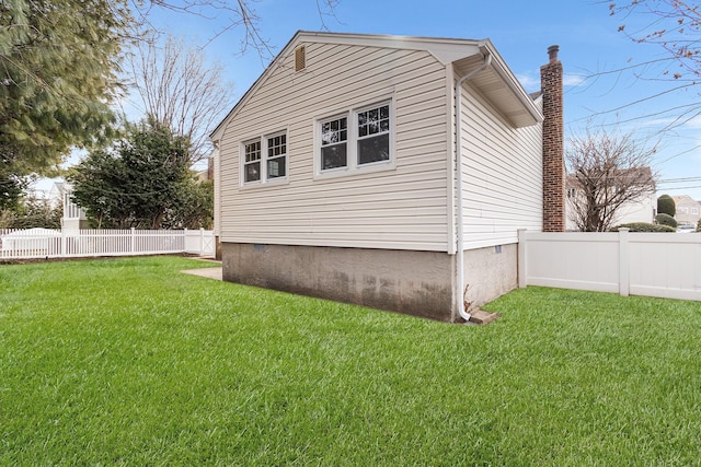 view of property exterior featuring fence, a chimney, and a lawn