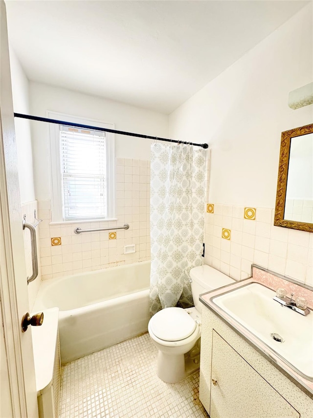 full bath with tile patterned flooring, toilet, vanity, shower / bath combination with curtain, and tile walls