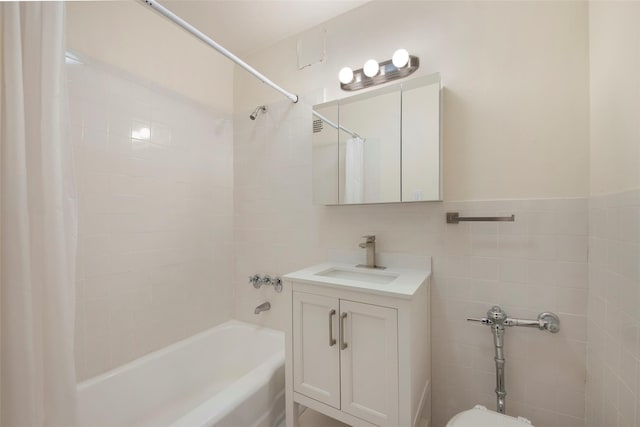 bathroom featuring shower / tub combo, tile walls, and vanity