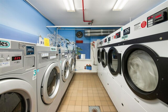 shared laundry area featuring light tile patterned flooring and independent washer and dryer