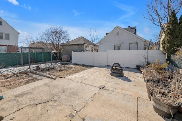 view of patio / terrace featuring an outdoor fire pit and fence